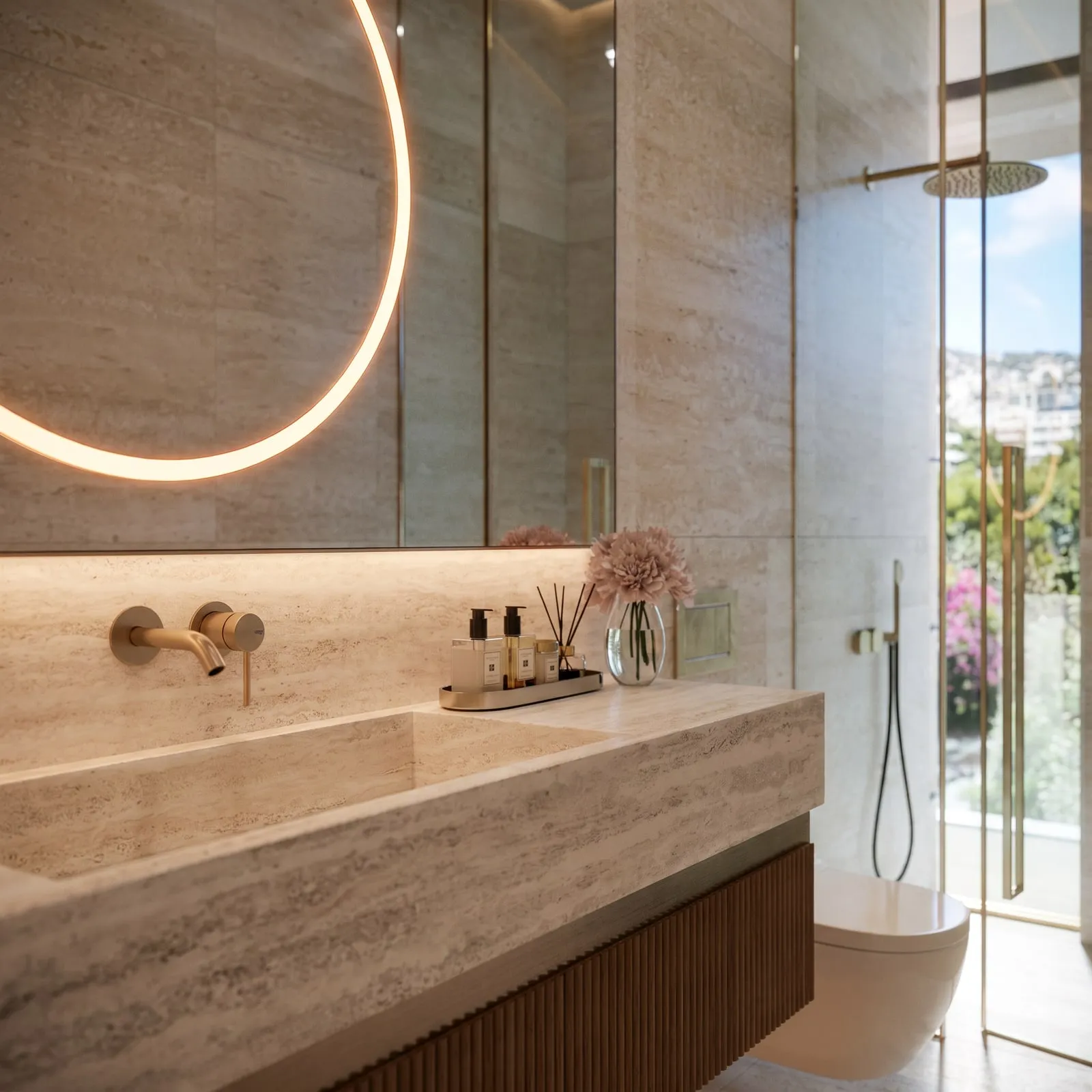 A stone basin under the bathroom’s softly lit circular mirror