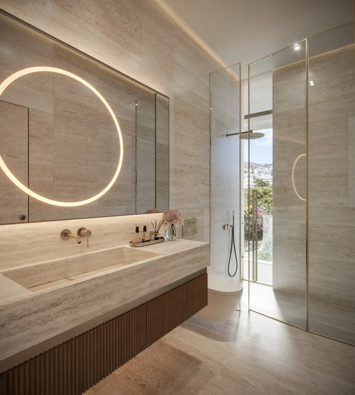 A Residence’s bathroom: travertine vanity, the ring of light and the glass shower