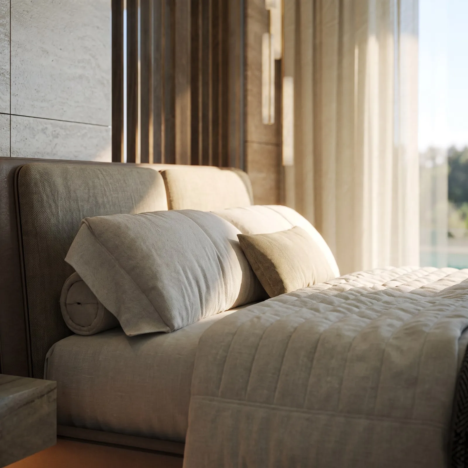 An upholstered bed with layered textiles in soft, warm tones