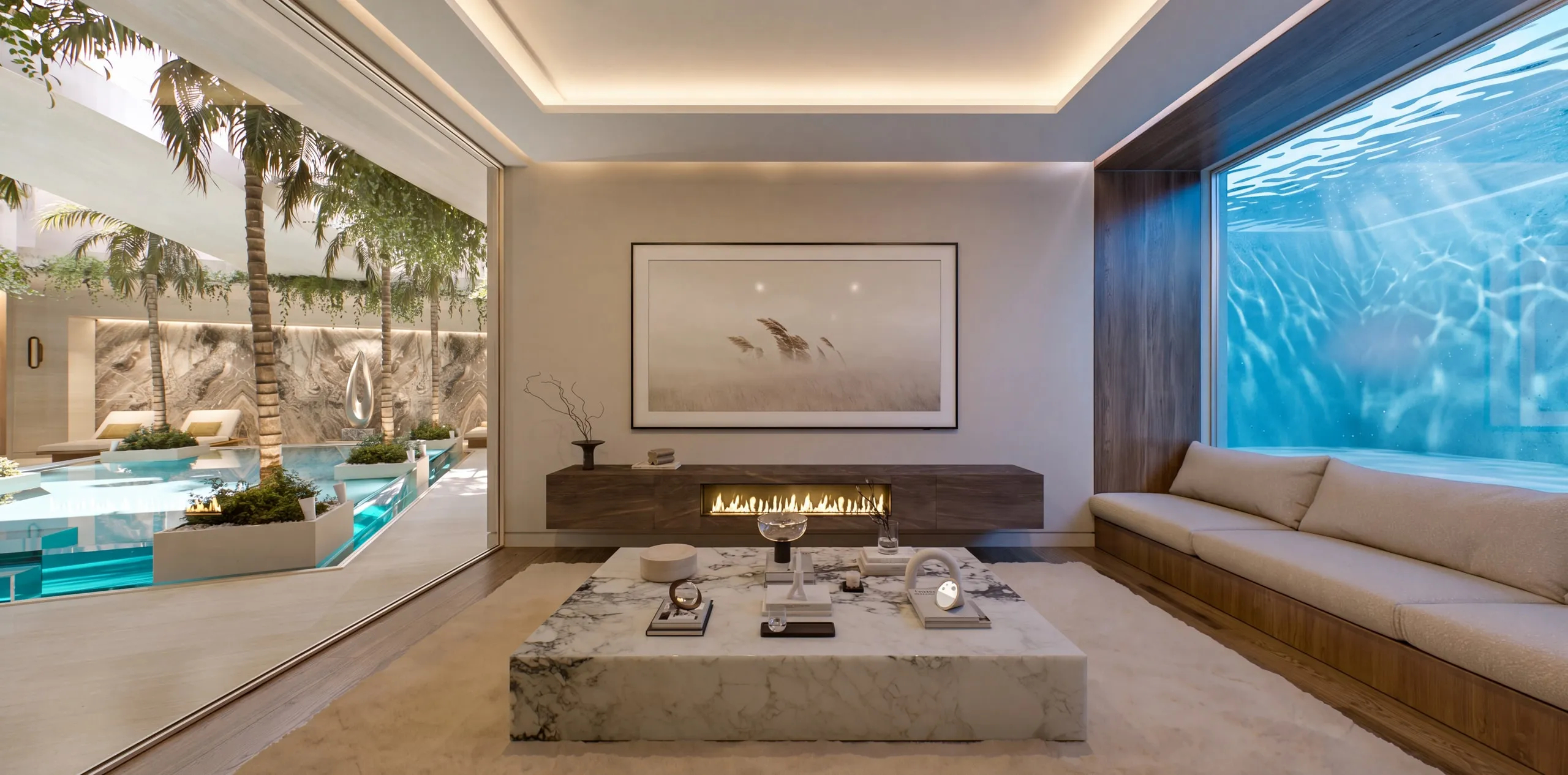 The Villa’s cinema room: pale sofas, a marble table, the fireplace and a window into the Pavilion’s pool