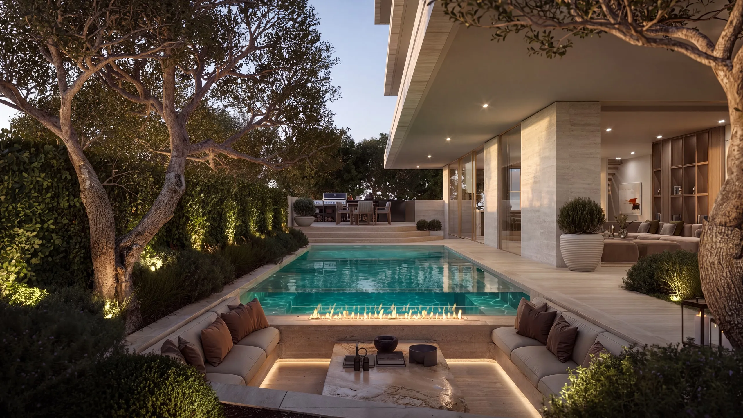 The Villa’s garden at dusk: the lit pool, the sunken lounge and the olive trees